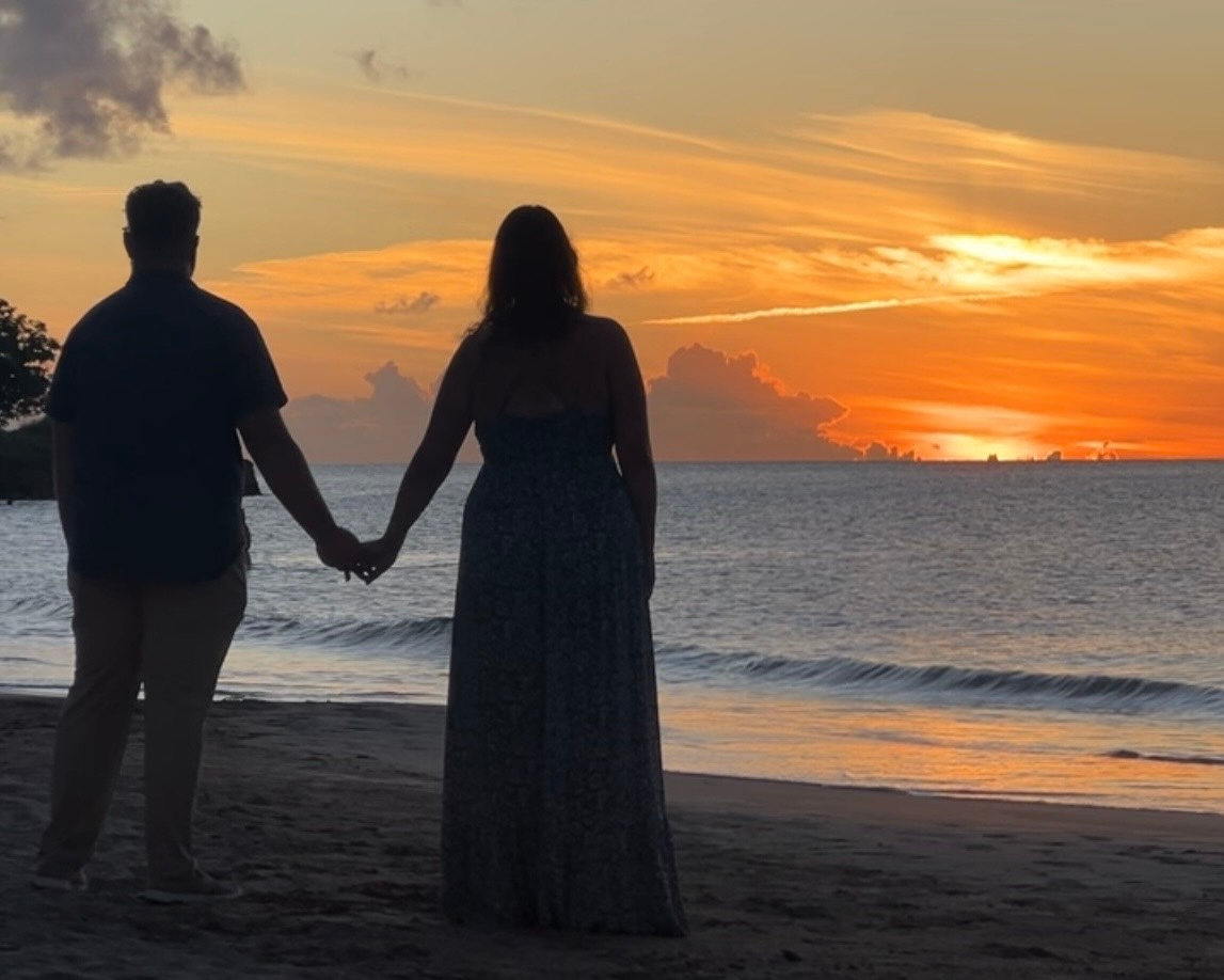 couple holding hands on the beach