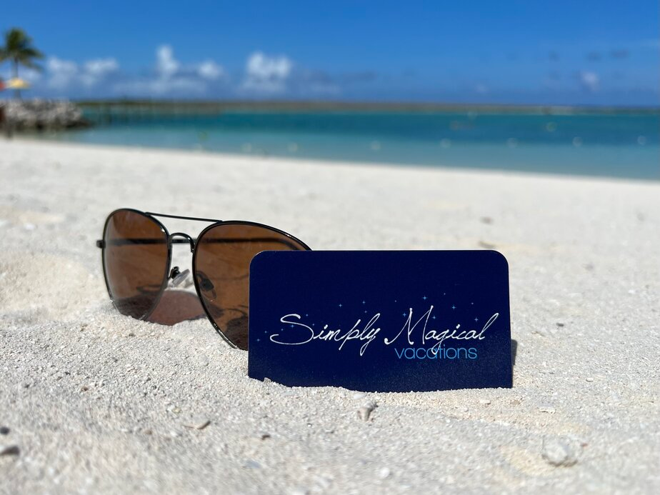 Sunglasses and business card on the beach
